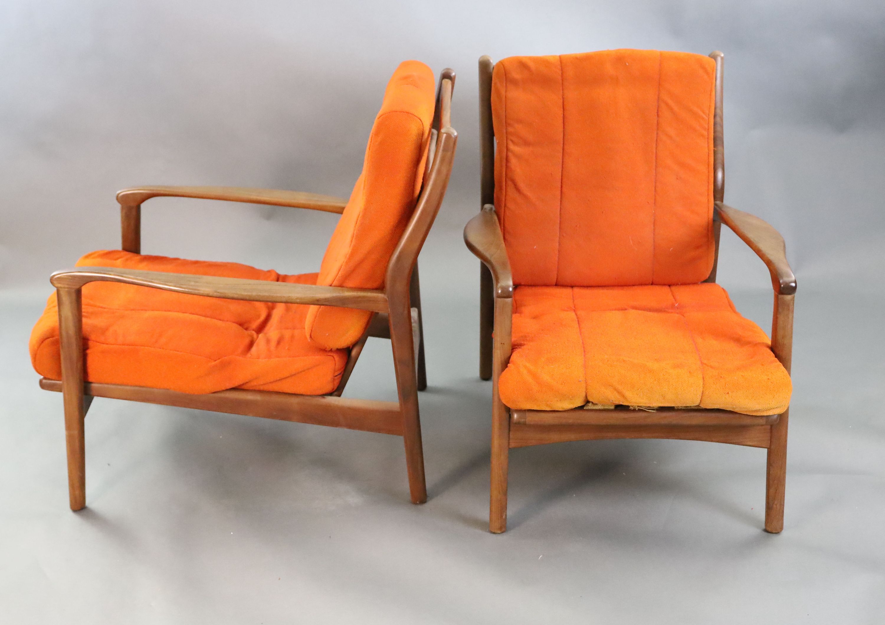 A pair of mid century Danish teak armchairs, W.2ft 2.5in. D.2ft 10in. H.2ft 8in.